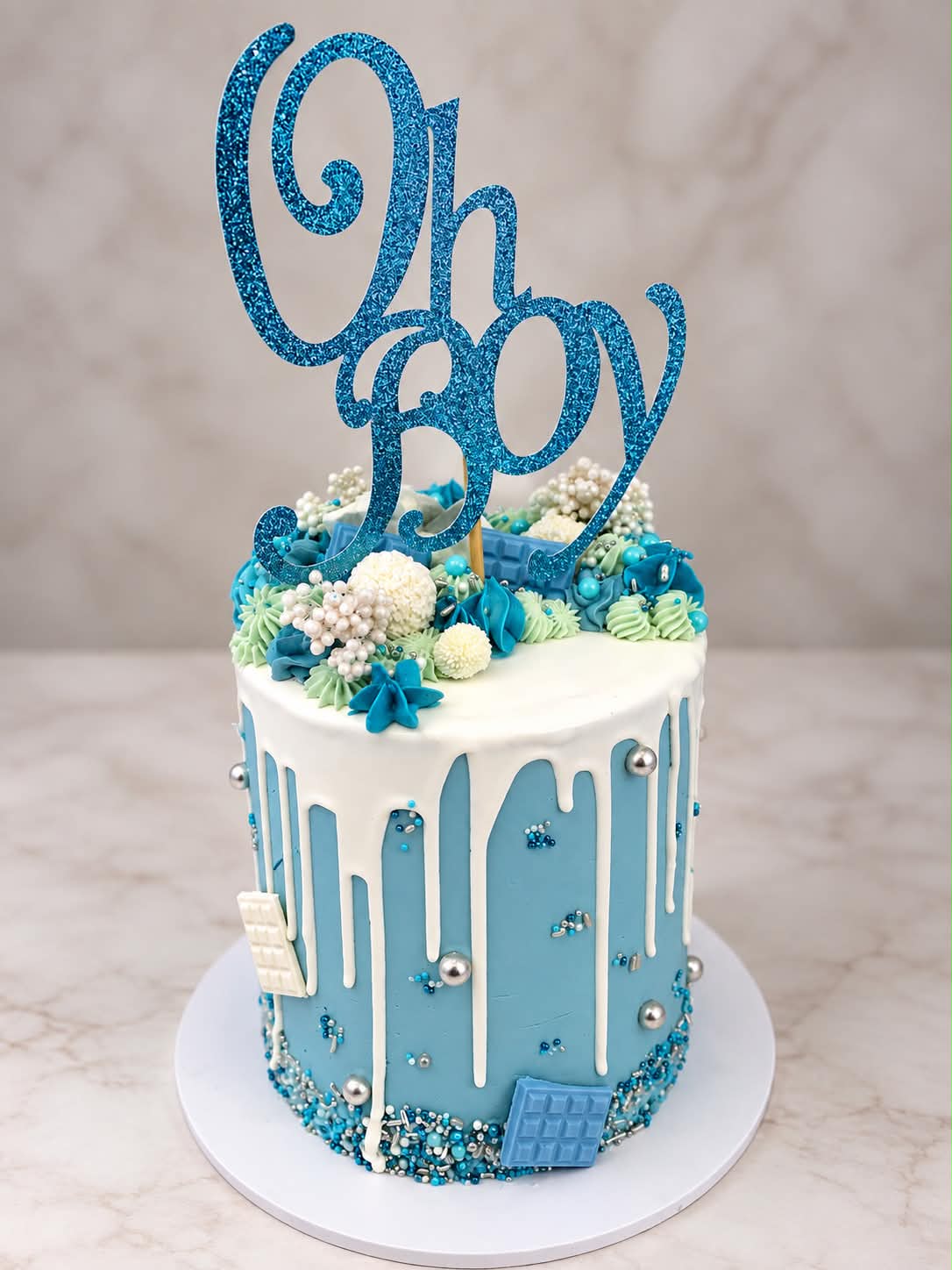 Soft blue baby shower cake with delicate detailing