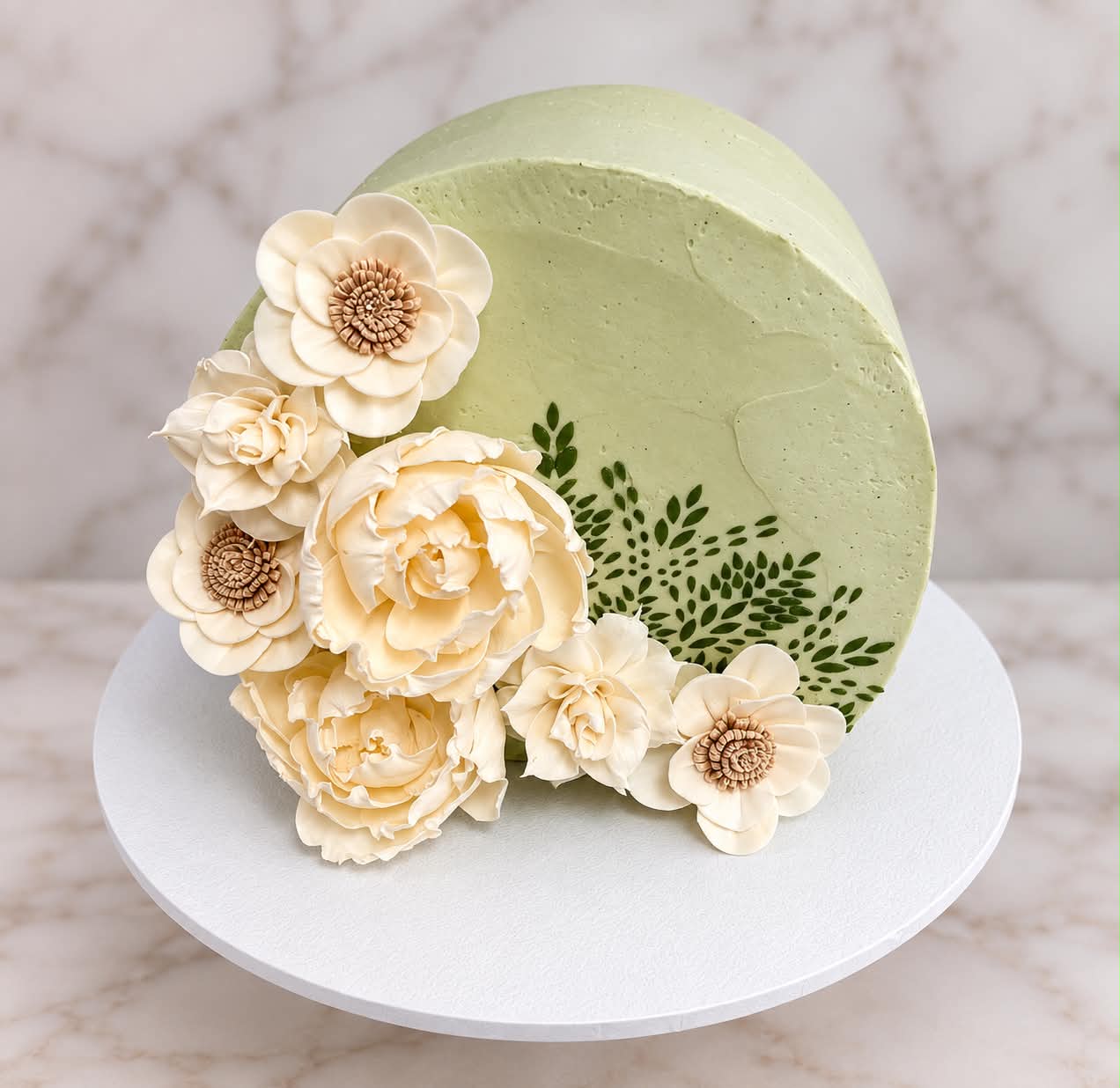 Green floral cake with acrylic disc topper